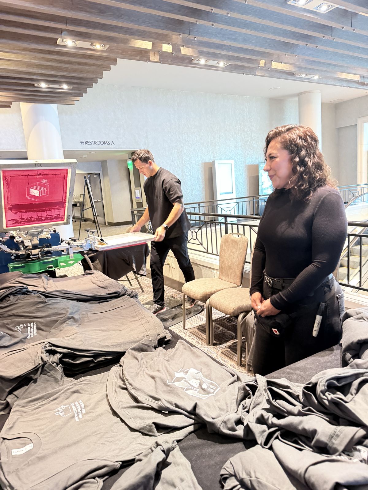 Merch Troop live printing — fresh prints off the platen